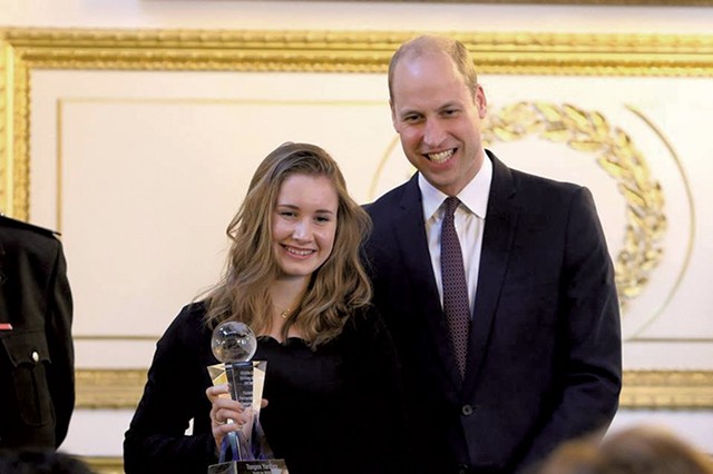 Taegen accepts a conservation award from Prince William - COURTESY OF TAEGEN YARDLEY