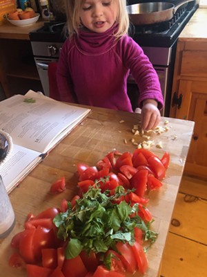 Rosie with ingredients for marinara sauce - HEATHER MOORE