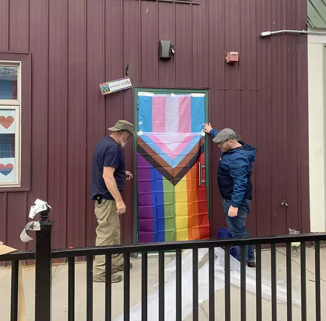 Mike Bensel, right, and a maintenance worker covering up the broken door on Tuesday morning - DEREK BROUWER ©️ SEVEN DAYS