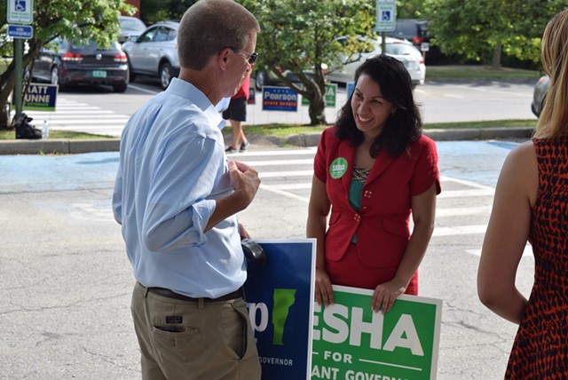 House Speaker Shap Smith (D-Morristown) and Rep. Kesha Ram (D-Burlington) chat Tuesday as they campaign outside the Burlington Electric Department polling station. - TERRI HALLENBECK