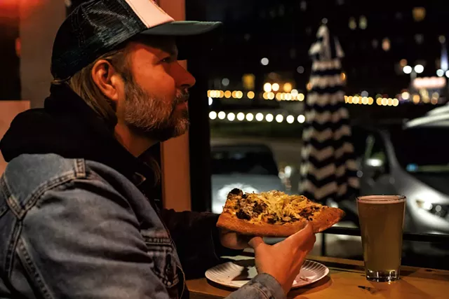 Danny LeFrancois, of Danny & the Parts, enjoying a brew and a slice of the McMonkey pizza - LUKE AWTRY