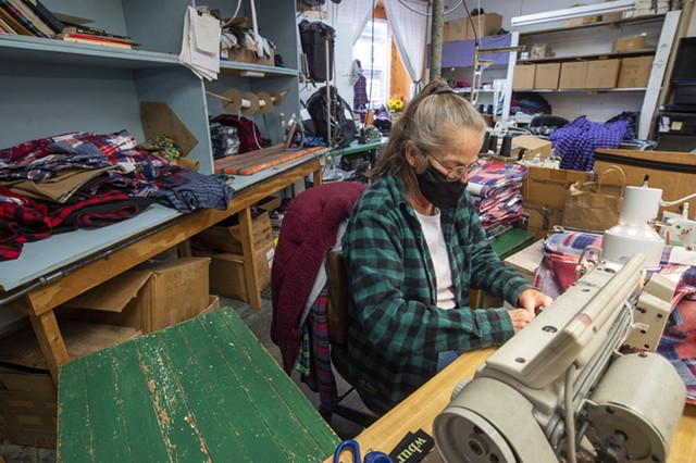 A worker sewing clothing at Vermont Flannel - JEB WALLACE-BRODEUR