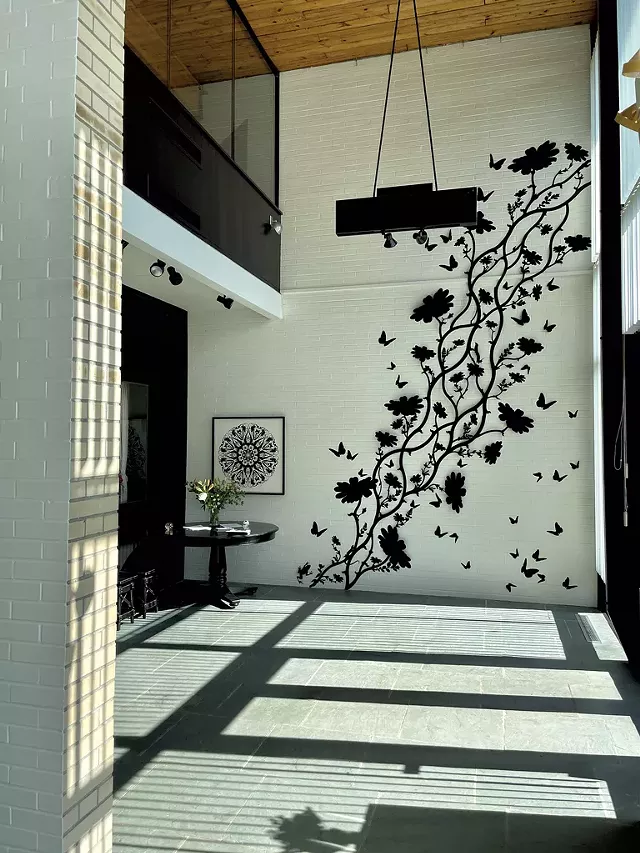 Untitled cut-paper installation by Randal Thurston on entry wall - COURTESY