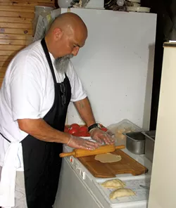 Manuel Aguilera making empanadas - ROBERT C. JENKS