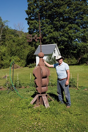 Daniel Quinn with the 200-year-old steeple ornament in his garden - BEN DEFLORIO