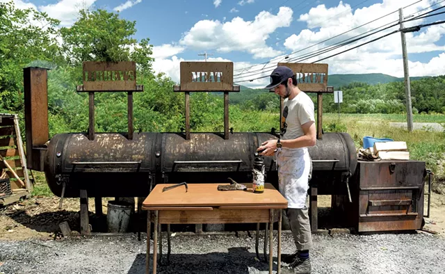 Libbey's staffer Brothaigh Mckowen checking the smoker - SUZANNE PODHAIZER