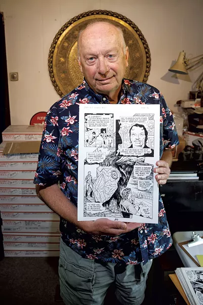 Rick Veitch holding a piece of art from Roarin' Rick's Rare Bit Fiends in his studio - ZACH STEPHENS