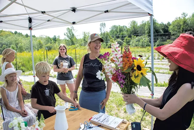 Christy Feiker of Glory Flower Farm interacting with customers - CALEB KENNA