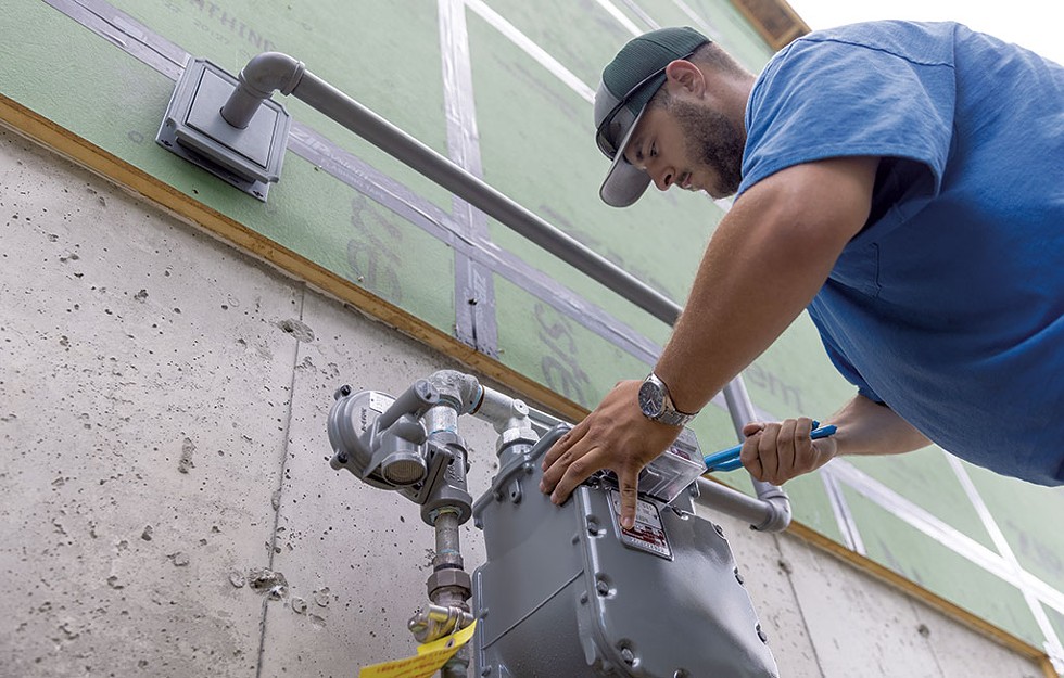 A Vermont Gas worker installing sevice in a new South Burlington neighborhood - JAMES BUCK