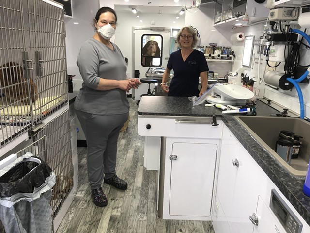 Deb Glottmann, left, and Susan Riggs in the Mitzvah Fund's mobile vet clinic - ANNE WALLACE ALLEN ©️ SEVEN DAYS
