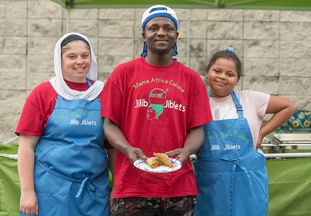 Said Bulle (center) of Jilib Jiblets displaying beef sambusas, flanked by his wife, Chelsea Domina, and daughter Maiya Abdalla, at Leddy Park Beach Bites - DARIA BISHOP