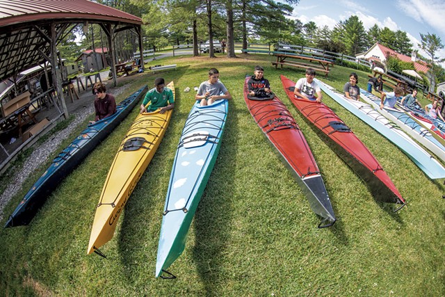 Campers getting ready to test their kayaks in the water - CAT CUTILLO