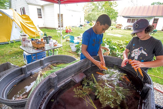 Zaal Niane (left) and Maddox Carter washing carrots - JEB WALLACE-BRODUER