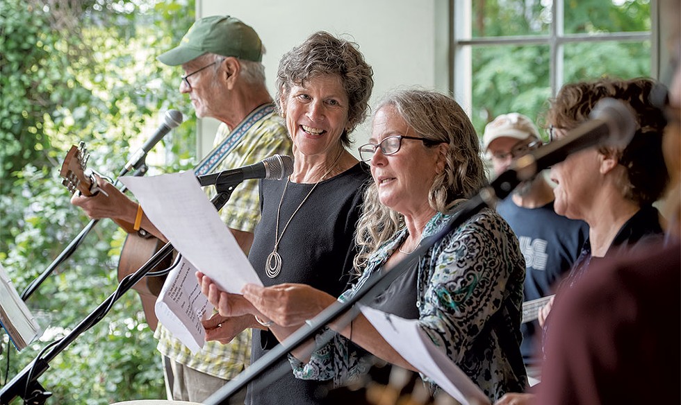 Rita Markley singing with colleagues Debbie Schlosser, Katherine Long and Tim Coleman at a retirement party for Coleman at COTS. - DARIA BISHOP