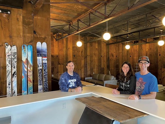 From left: J Skis headquarters manager Doug Stewart with Corrine and J Levinthal in the company's lounge and bar - COURTESY