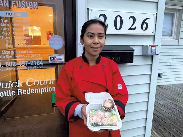 Pho Vo owner Phuong Lam holding fresh shrimp spring rolls - MELISSA PASANEN