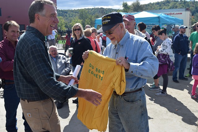 Mick Winter of Barre shows Phil Scott a DuBois bowling team T-shirt from the 1960s at the company’s party Saturday. - TERRI HALLENBECK