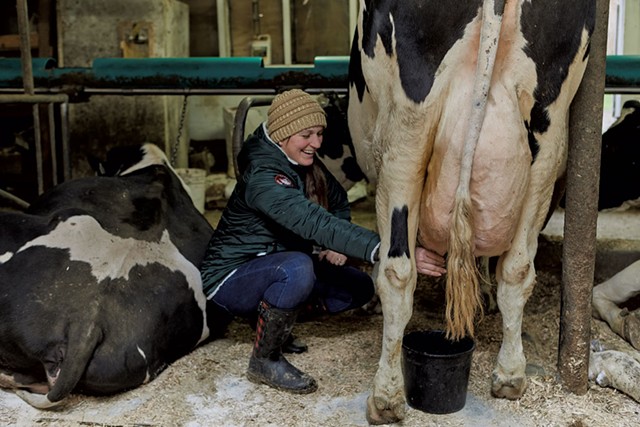 Asia Kennett milking a dairy cow in the barn - COURTESY OF JESSICA SIPE