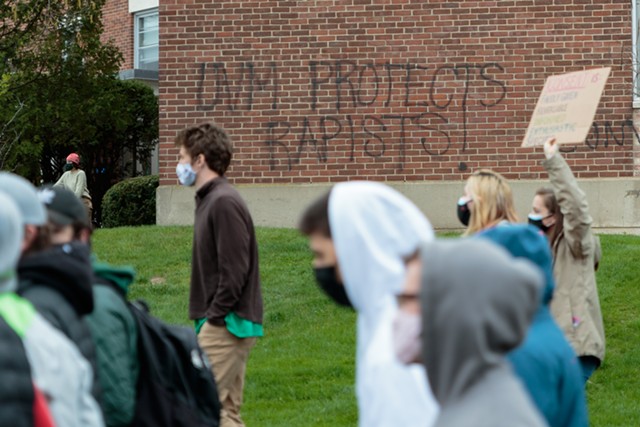 Students march past graffiti criticizing UVM in 2021 - FILE: COLIN FLANDERS ©️ SEVEN DAYS