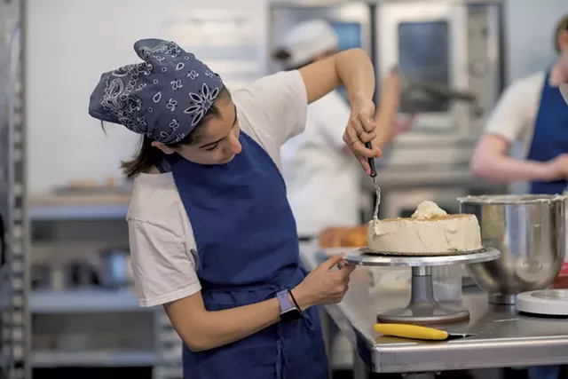 Jessie Tarnoff frosting a Medovik cake - DARIA BISHOP