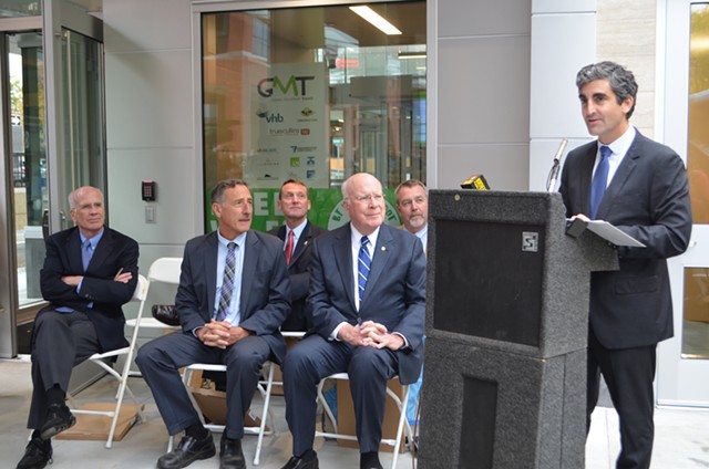 Mayor Miro Weinberger addresses the gathering. Seated, from left to right: Rep. Peter Welch (D-Vt.), Gov. Peter Shumlin, Peter Butler of the Federal Transit Administration, Sen. Patrick Leahy (D-Vt.) and Agency of Transportation Secretary Chris Cole - SASHA GOLDSTEIN
