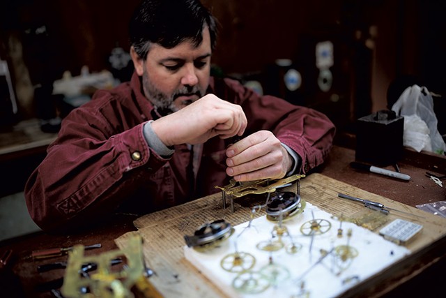 Skip Sjobeck fixing a clock - BEN DEFLORIO