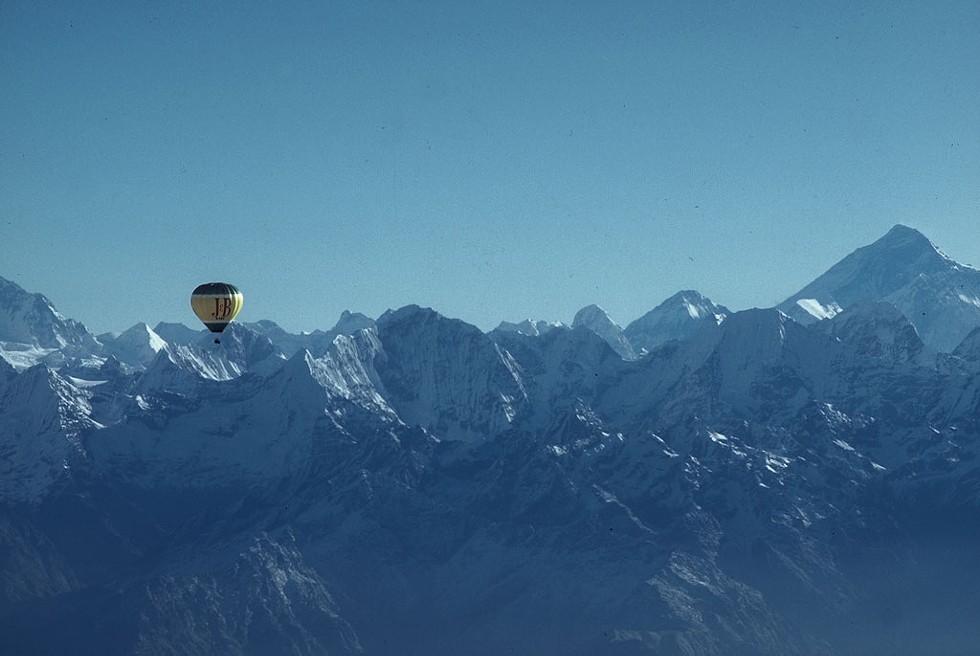 Jan Reynolds in a hot-air balloon approaching Mount Everest (right) - COURTESY OF JAN REYNOLDS