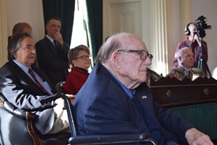 Bill Doyle listens as senators honor him, while Gov. Phil Scott looks on. - TERRI HALLENBECK