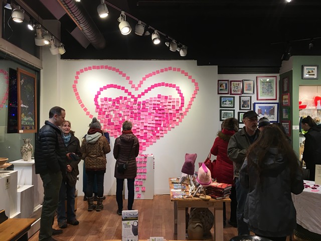 Visitors place notes on the "Wall of Love" at Frog Hollow - SADIE WILLIAMS