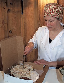 Caroline Demers cutting maple buns at Red House Sweets - SUZANNE PODHAIZER