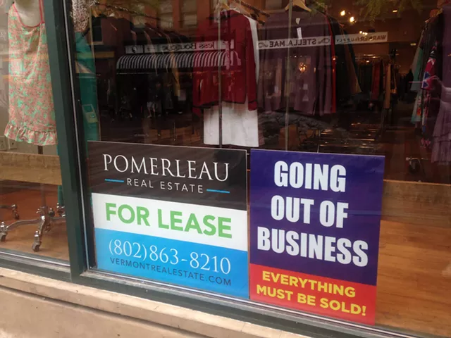 Signs in the 2nd Time Around store windows - MOLLY WALSH