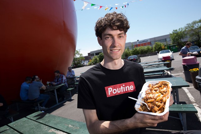 Nicolas Fabien-Ouellet, a student in the University of Vermont's Food Systems Master's program, with an order of poutine from Orange Jules in Montreal. - OWEN EGAN