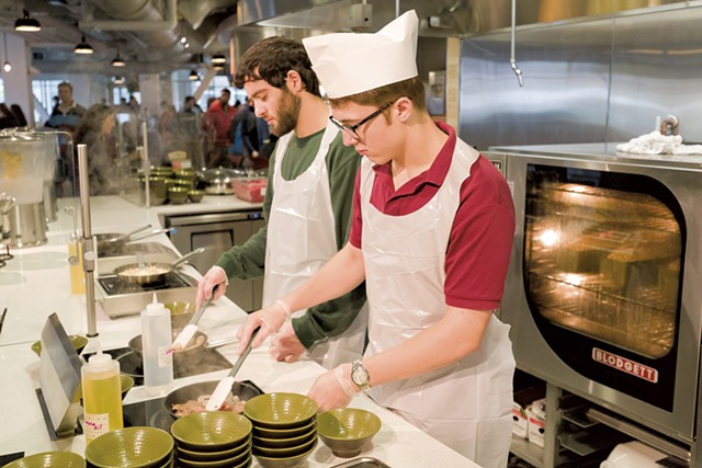 UVM students Julian Wagner (right) and Nicholas Vartanian cooking for themselves in the Central Campus Dining Hall - OLIVER PARINI