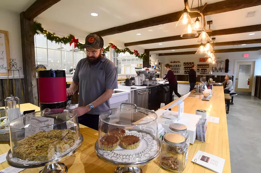 Max Duquette working the counter at the new Vermont Artisan Coffee & Tea - JEB WALLACE-BRODEUR