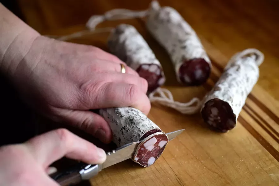 Erika Lynch cutting her slow-cured salami - JEB WALLACE-BRODEUR
