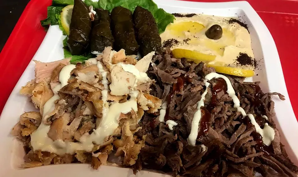 Chicken and beef shawarma with hummus and stuffed grape leaves at Mr. Shawarma - COURTESY OF MR. SHAWARMA
