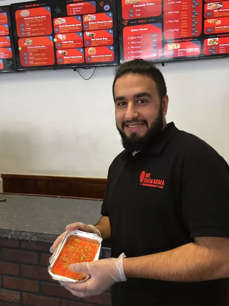 Sam (Usamah) Abdulkhaleq with a traditional dessert called kunefe - MELISSA PASANEN
