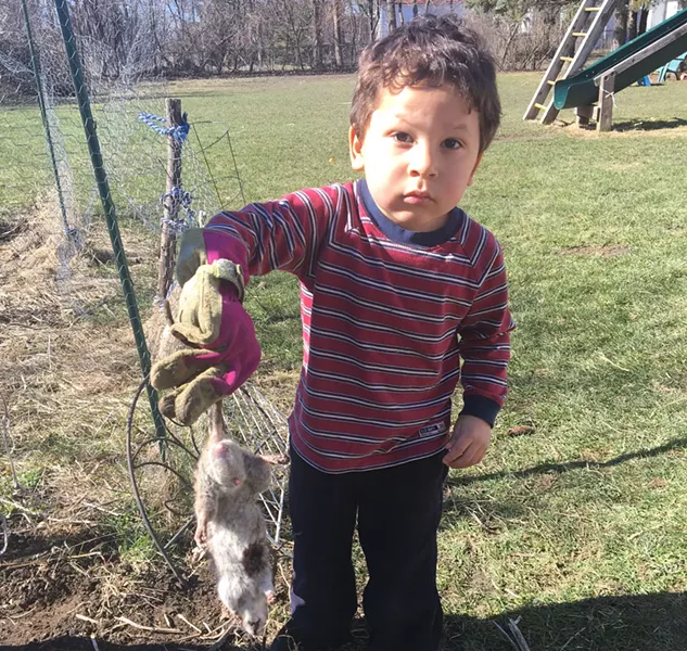 Basil Chadwick holding up a dead rat - COURTESY OF MARTHA CHADWICK