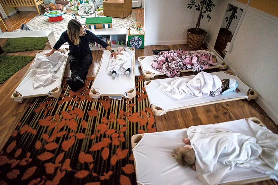 Kate Driver soothing sleepy children during nap time - GLENN RUSSELL