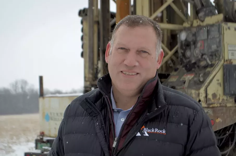 Ben Avery of BlackRock Construction in front of well-drilling equipment in Hinesburg - PHOTOS: MOLLY WALSH