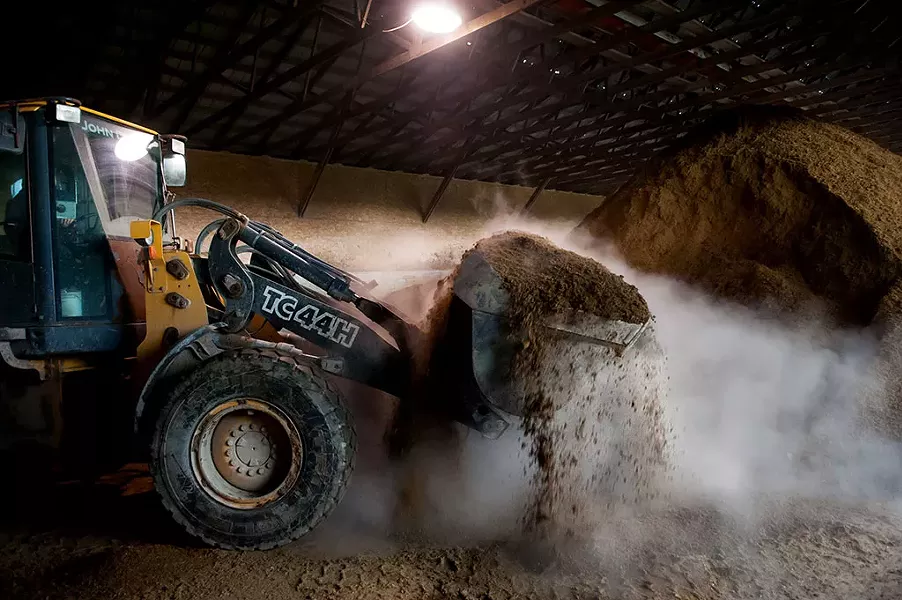 Tractor at Blue Spruce Farm scooping up separated, digested plant fibers used as fluffy bedding for cows - © CABOT CREAMERY CO-OPERATIVE