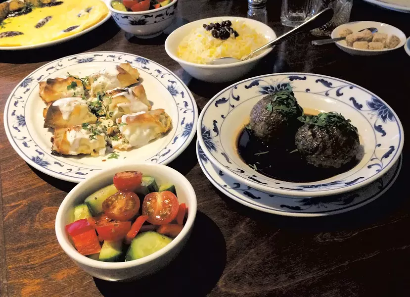 Clockwise from top: basmati rice with barberries, koufteh, salad, Persian borek and a firdaus omelette at Rumi - MOLLY ZAPP