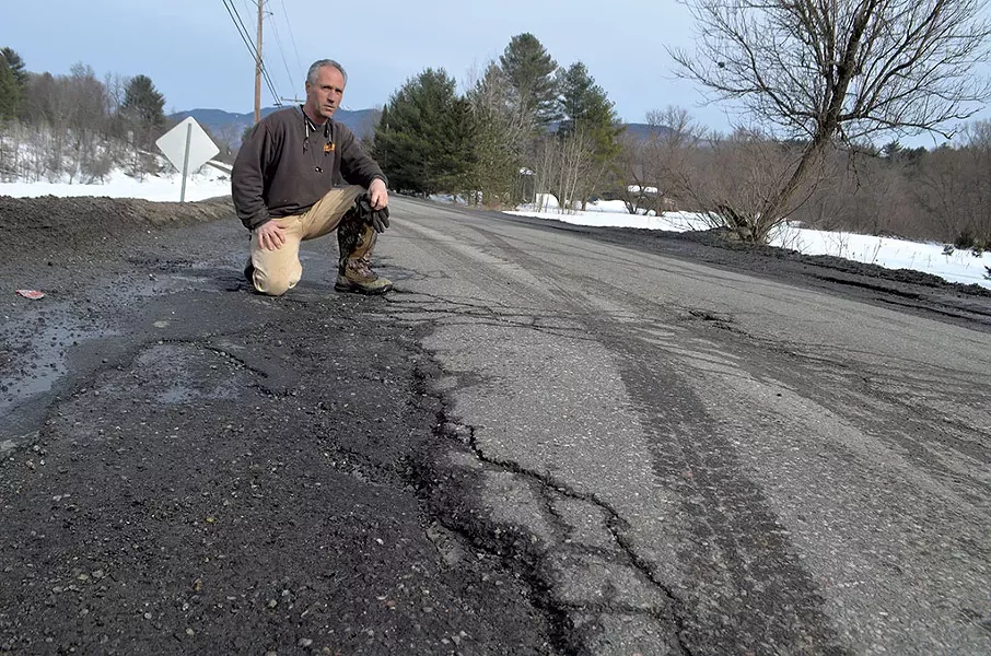 Chris Viens surveying the poor condition of Guptil Road near his Waterbury home - KEVIN MCCALLUM
