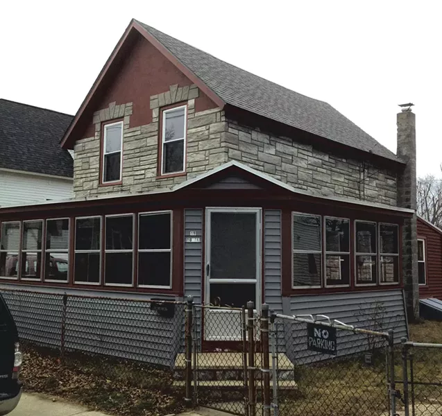 March 2013: When purchased, the circa-1913 house had concrete siding and an enclosed porch. A chain-link fence ran the border of its property. - COURTESY OF GRAHAM MACHARG