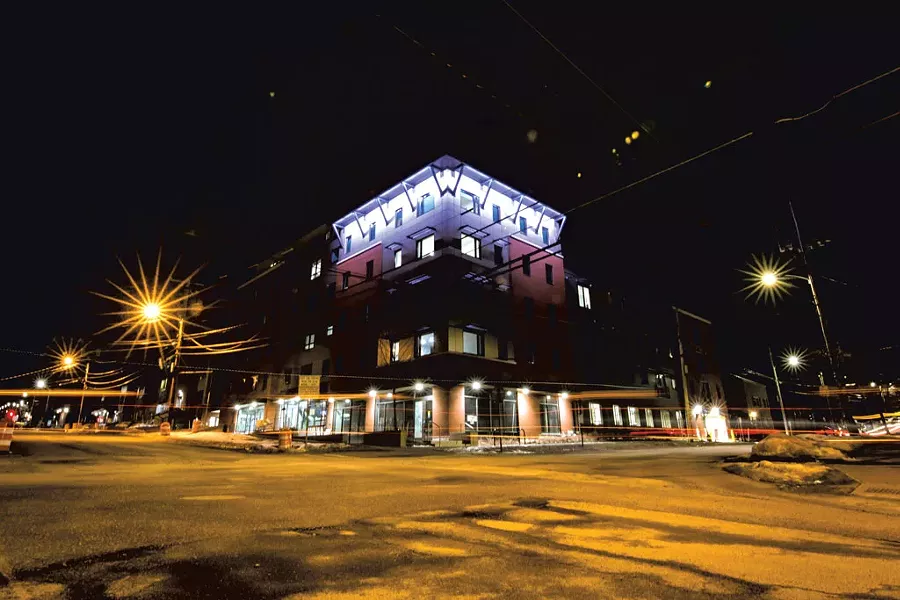 At night, faÇade lighting accentuates architectural details on the building - LUKE AWTRY