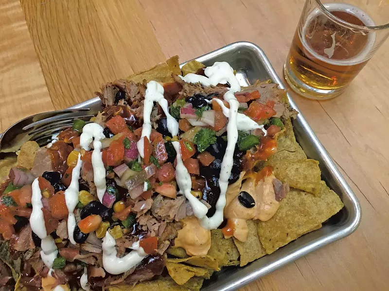 Hickory-smoked pork nachos and beer at the Otter Creek Brewing pub - MELISSA PASANEN