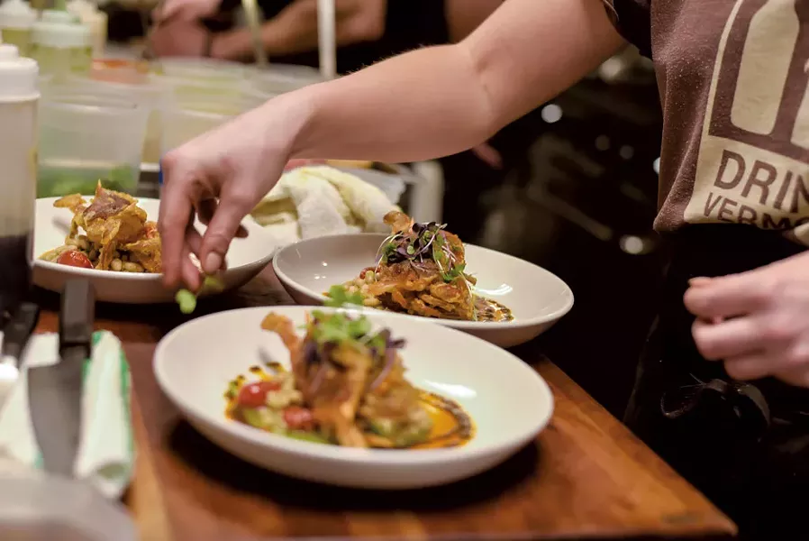 Charlotte Harvey plating three orders of soft-shell crabs - GLENN RUSSELL