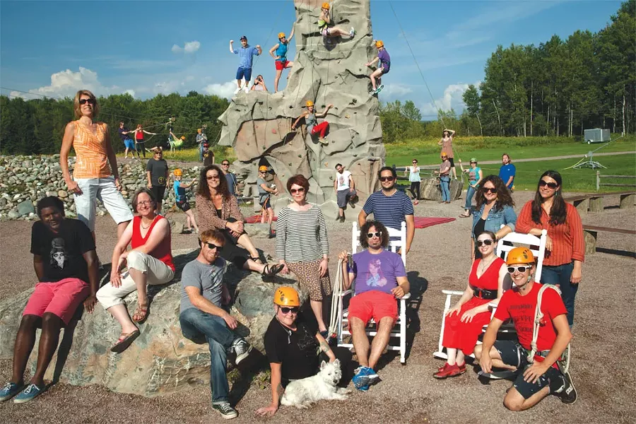 FRONT ROW, SITTING, LEFT TO RIGHT: Bobby Hackney, Cathy Resmer, Paula Routly, Dan Bolles, Diane Sullivan with Rufus, Colby Roberts, Alice Levitt, Don Eggert. - FRONT ROW, STANDING, LEFT TO RIGHT: Michelle Brown, Pamela Polston, Steve Hadeka, Tiffany Szymaszek, Courtney Copp. - MIDDLE GROUND, LEFT TO RIGHT: Robyn Birgisson, Cheryl Brownell, Ken Picard, Corey Grenier, John James, Corin Hirsch, Charles Eichacker, Kaitlin Montgomery, Paul Heintz. - BACK, LEFT TO RIGHT: Michael Bradshaw, Britt Boyd, Brooke Bousquet, Aaron Shewsbury, Tyler Machado, Matt Weiner & Matt Thorsen (Photoshopped in sans helmet!), Eva Sollberger, Megan James, Emily Rose, Sarah Cushman, Margot Harrison. - ON T-SHIRTS: Ashley Cleare, Carolyn Fox, Katie Flagg. - PHOTO: Matthew Thorsen. - Thanks to Northern Lights Rock and Ice at The Essex for roping us in.