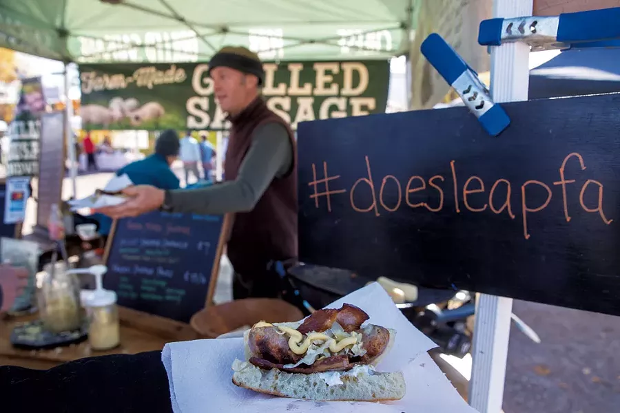 George van Vlaanderen serving a grilled sausage sandwich at the Doe's Leap Farm booth - JAMES BUCK