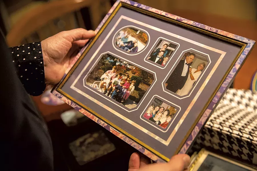 June Kelly holding family photos - JAMES BUCK